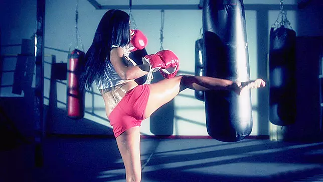 Boxer girl Aryana Augustine hitting the bag in the gym